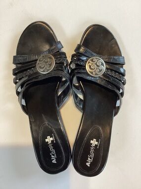 Black Slide Mules with Decorative Silver Emblem